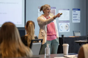 Female adult instructor at front of class